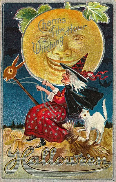 Halloween: a witch and black cat before the harvest moon