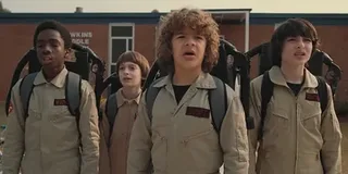 The boys of Hawkins trick-or-treat as the Ghostbusters in Stranger Things
