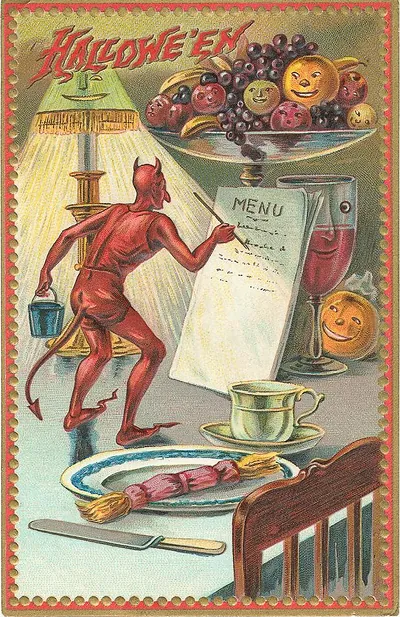 Hallowe'en: a devil reading the menu at a party table