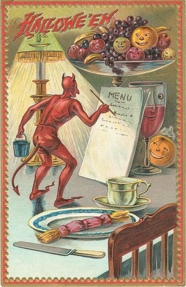 Hallowe'en: a devil reading the menu at a party table, Early 1900s — vintage postcard