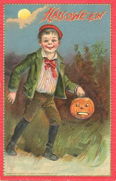 Hallowe'en: a boy carrying a jack-o'-lantern