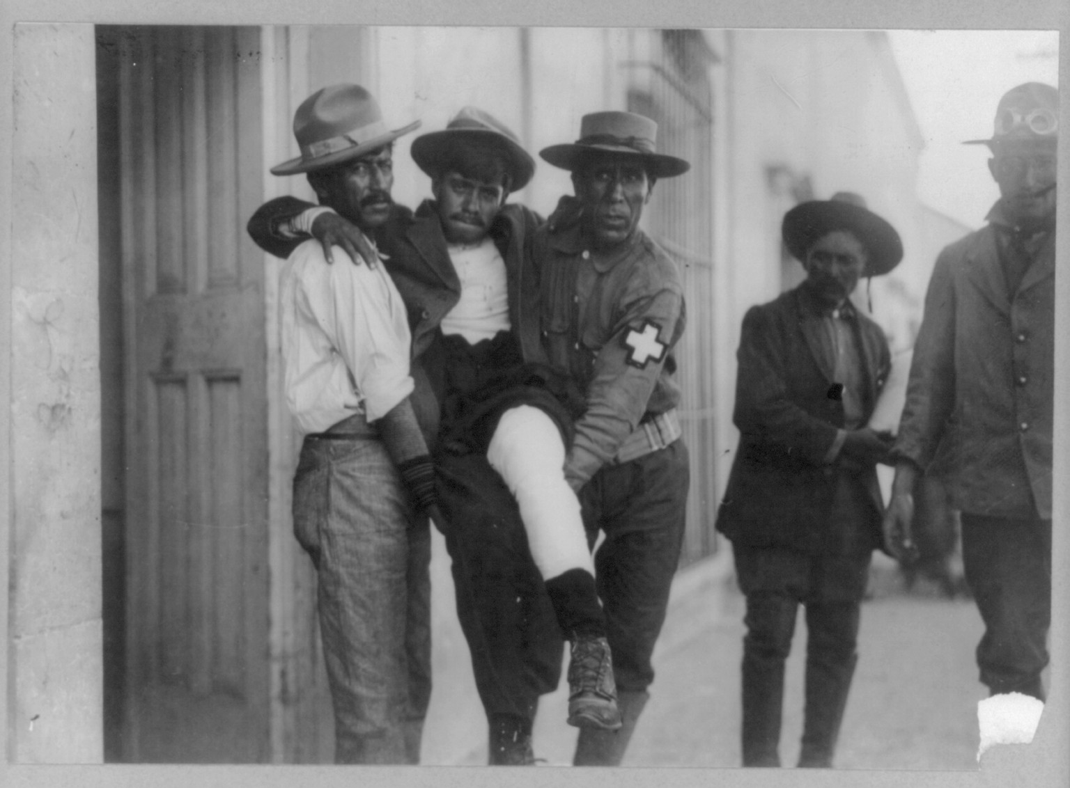 [2 medics carrying wounded Mexican insurgent] — historic photograph
