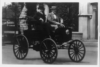 [Two men in the first American automobile, 1890's]