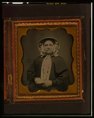 Unidentified woman in bonnet and shawl, framed daguerreotype