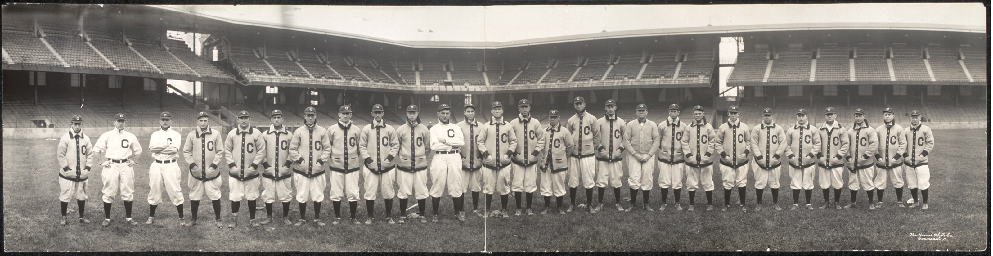 Panoramic photograph of a baseball team in stadium, Cleveland uniforms, 1910 — historic photograph