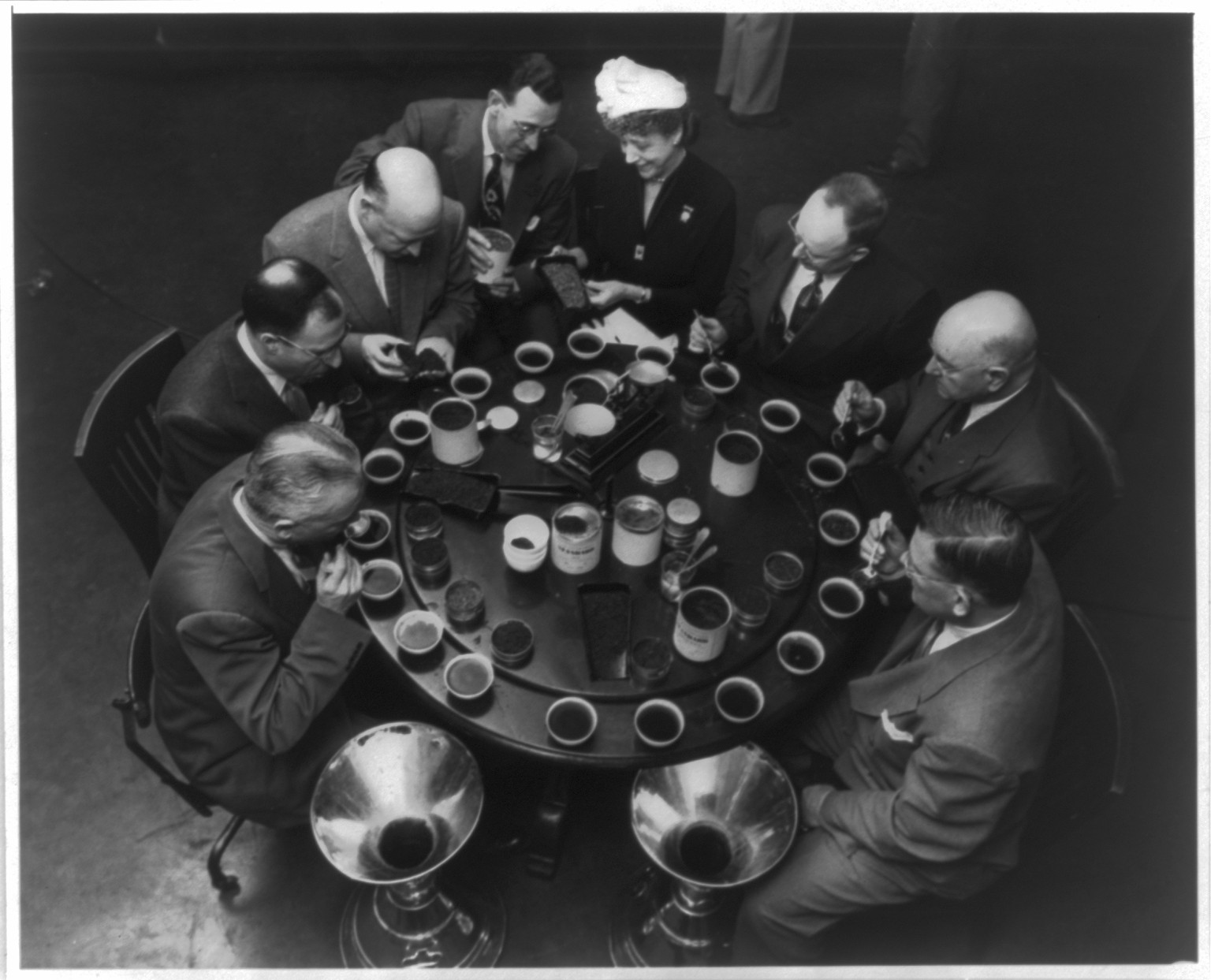 Mrs. Lyonel Robinson, pres. of the N.Y.C. Federation of Women's Clubs, sits with U.S. Board of Tea Experts: Robert H. Dick, J. Grayson Lutrell, Joseph Vaskas, Jack Halloran, Carl Seeman, Jr., G.T. McCalley and Edward Spillane., 1954 Feb. 8. — historic photograph