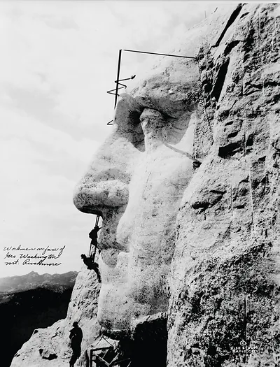 Workmen on face of Geo. Washington, Mt. Rushmore