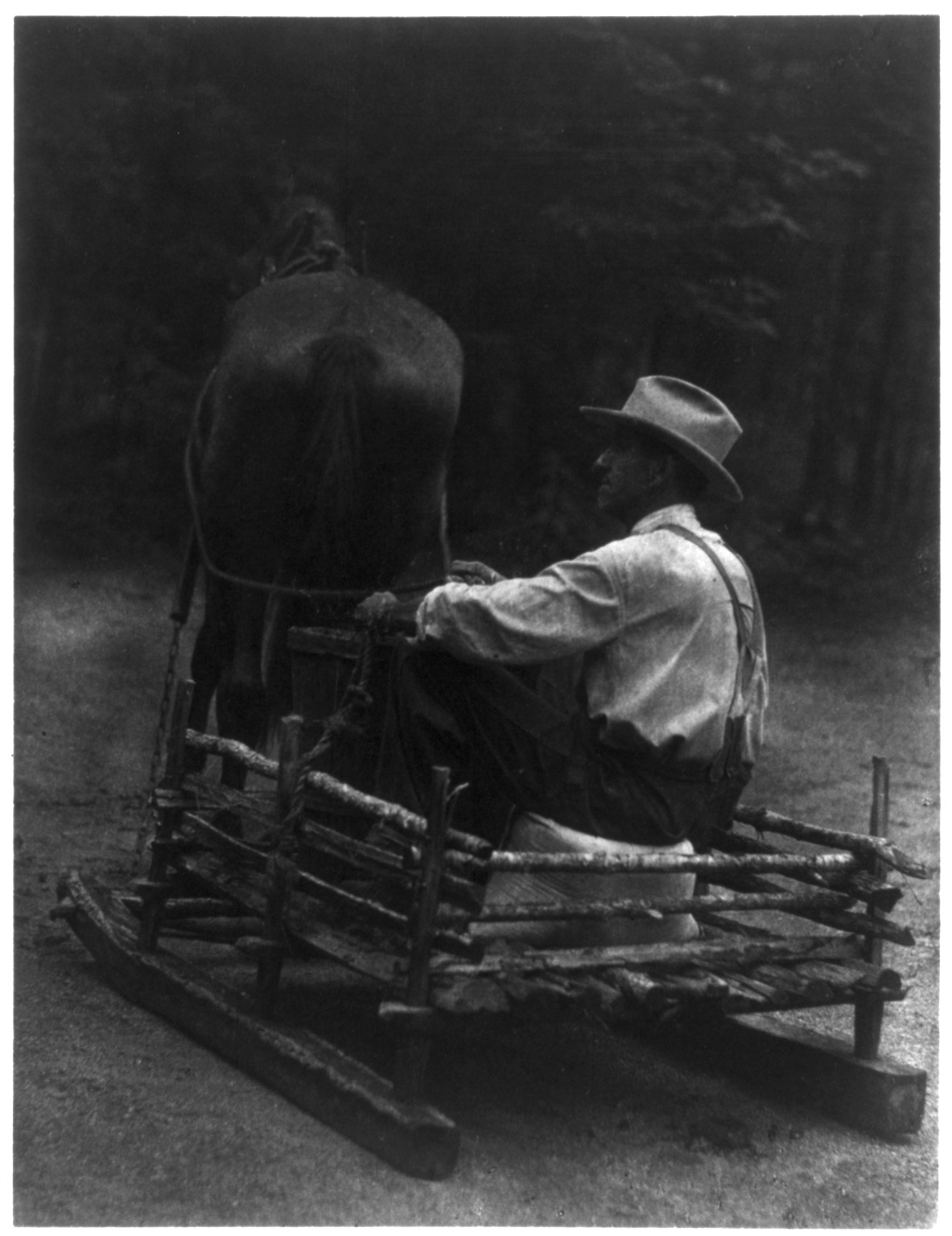 [Man seated in a sled, driving a horse], [ca. 1930] — historic photograph