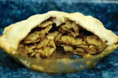 Sliced apple pie in a glass dish