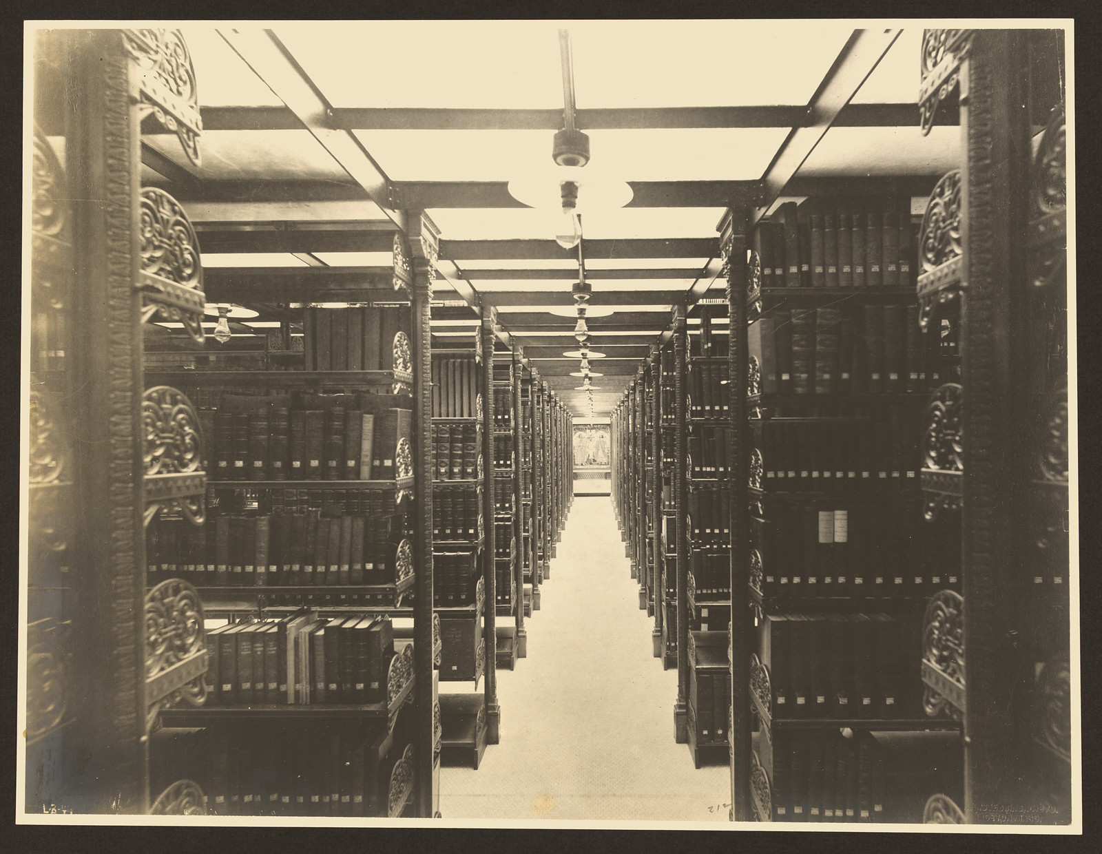 Cast-iron library stacks in a bookroom aisle — historic image