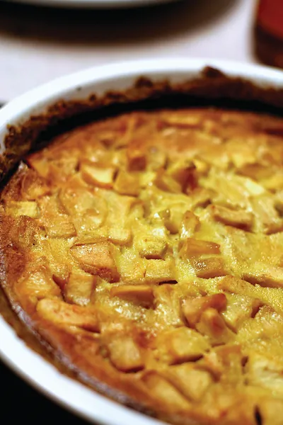 Baked apple tart in a white dish