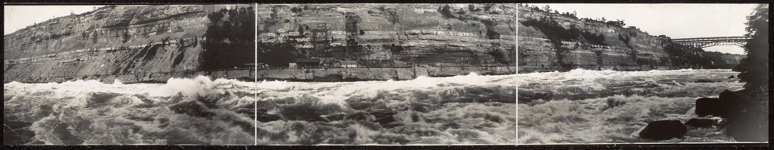 Panoramic photograph of rapids below gorge cliffs — historic photograph