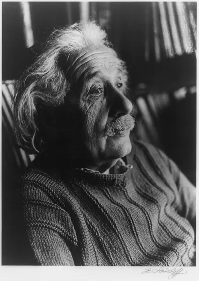 [Albert Einstein, head-and-shoulders portrait, facing right]
