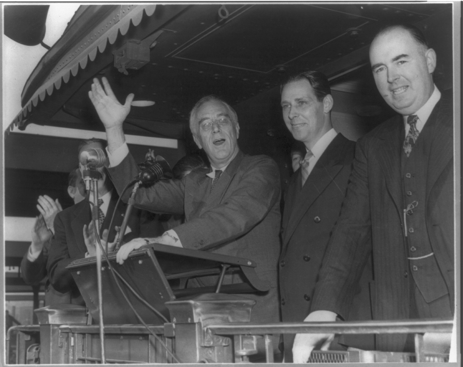 [Franklin Delano Roosevelt, half, facing front, speaking from train at Springfield, Mass., Nov. 4, 1944; standing with Maurice J. Tobin, Mayor of Boston, and Wm. Burke, Mass., Democratic chairman] — historic photograph