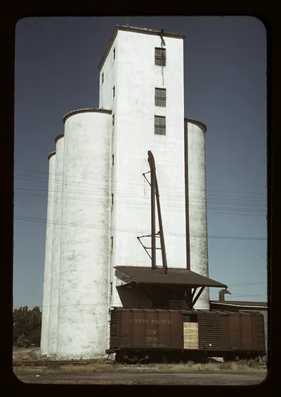 Concrete grain elevator with silos and Union Pacific boxcar
