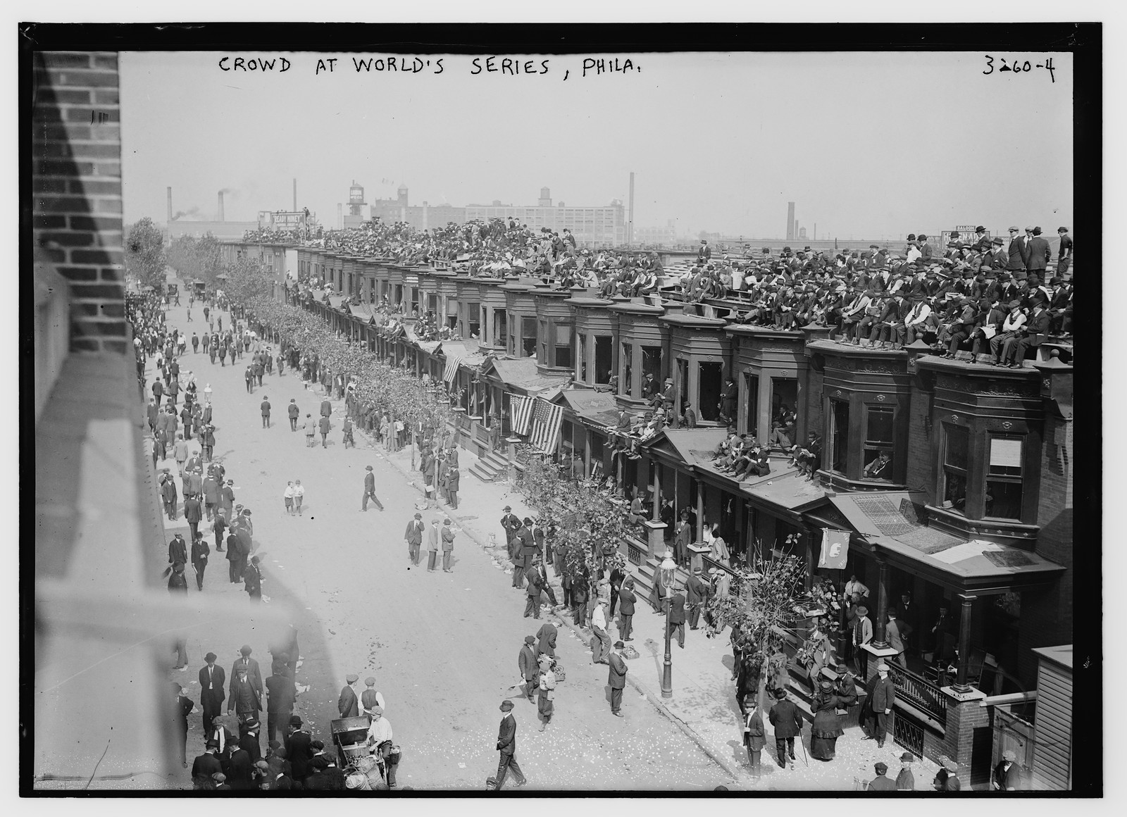 Watching series game from rooftops, n/a — historic photograph