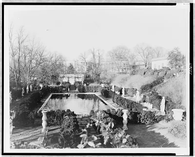 [View of garden, with pool and statues, and house in background, on estate of Evalyn Walsh McLean]