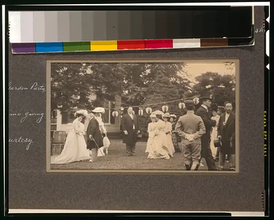 Garden party with guests in formal dress, photographed outdoors