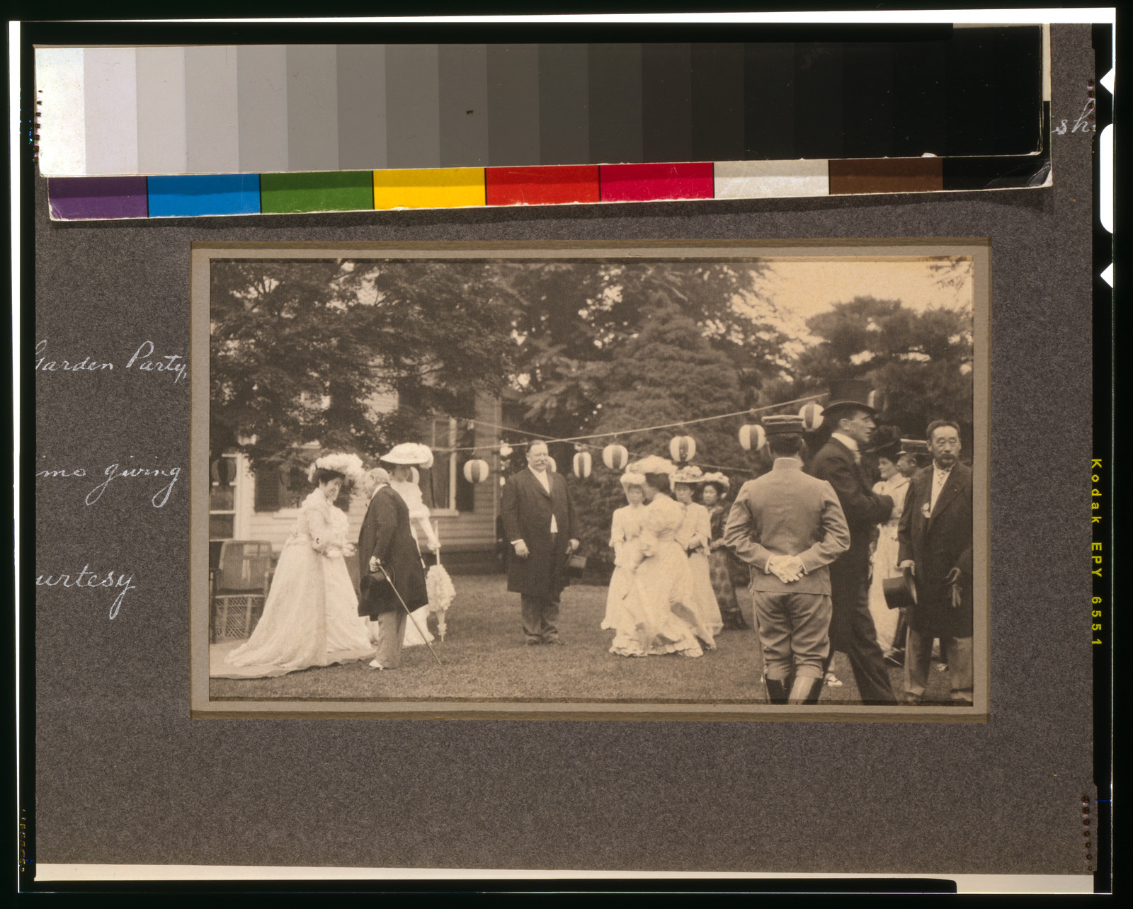 Garden party with guests in formal dress, photographed outdoors — historic photograph