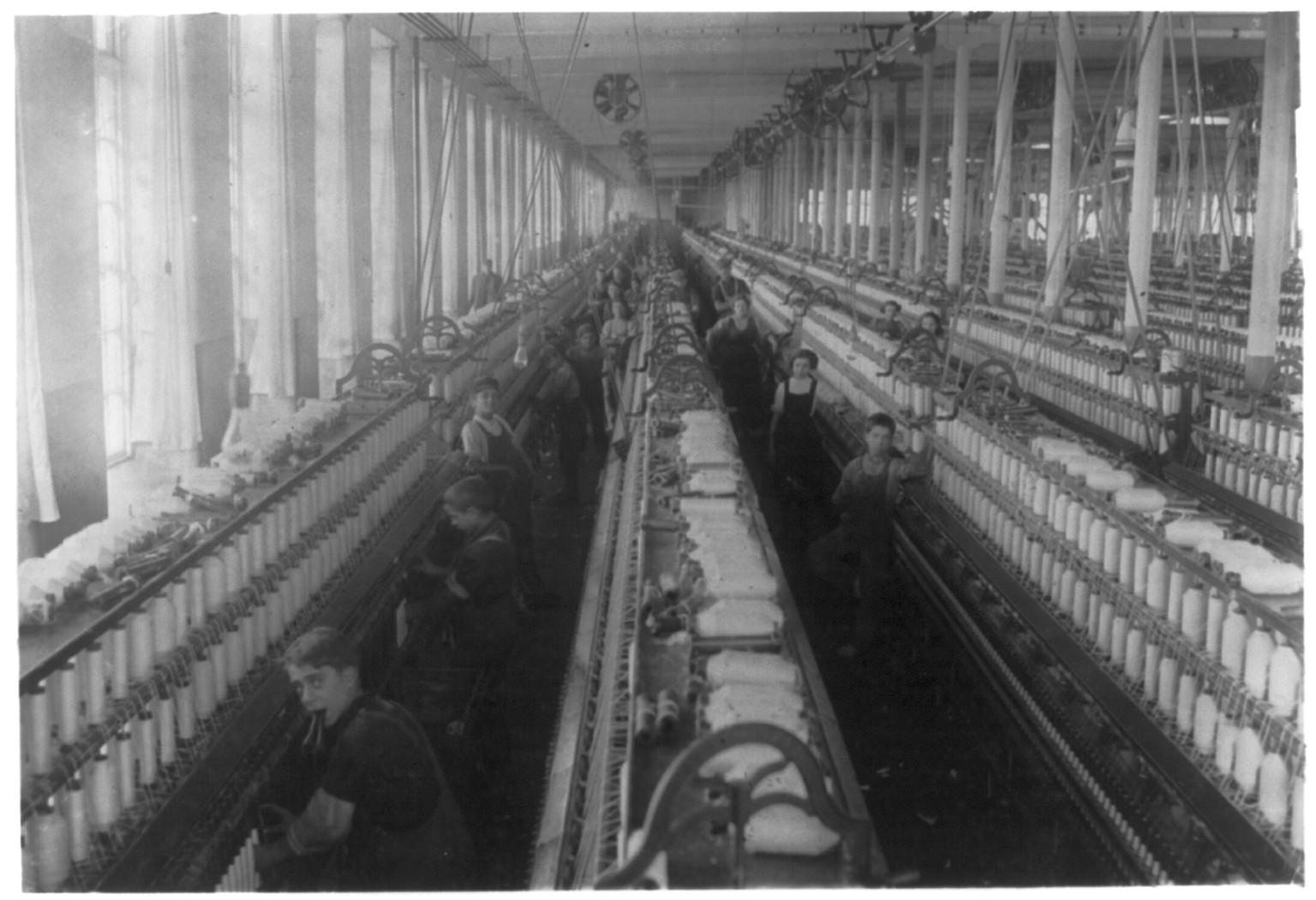General view of the spinning room, Cornell Mill, showing some of the young boys and girls employed there. See names on other photo. Cornell Mill. Location: Fall River, Massachusetts., 1912 January. — historic photograph