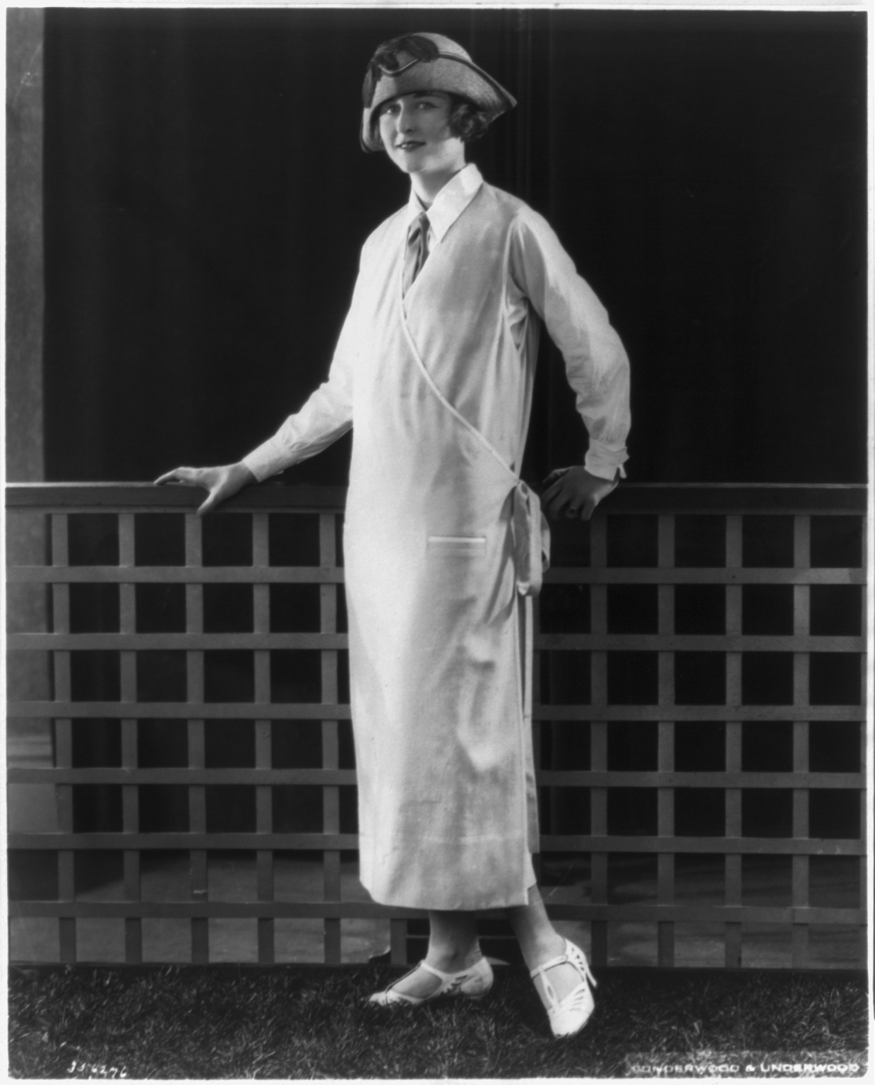 [Woman modeling clothing: Sky-blue flannel piped with white makes up this one-piece dress from Davidow Sons], c1924. — historic photograph
