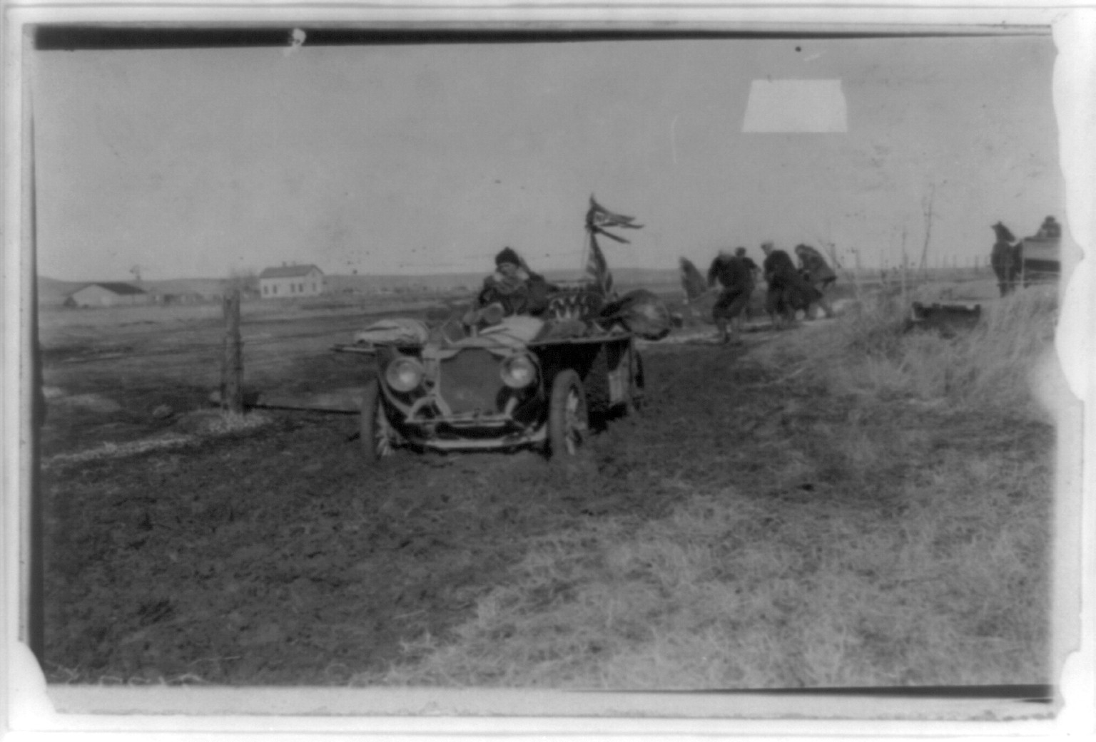 [New York to Paris automobile race - five men trying to pull automobile out of mud], c1905(?) — historic photograph
