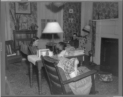 [Germantown, New York. Frances Martin, who does farm work, is sitting in the living room with Mr. and Mrs. Schrader]