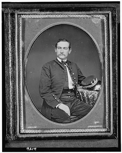 [John M. Bradhurst, three-quarter length portrait, facing slightly left, seated with arm on table with tablecloth]