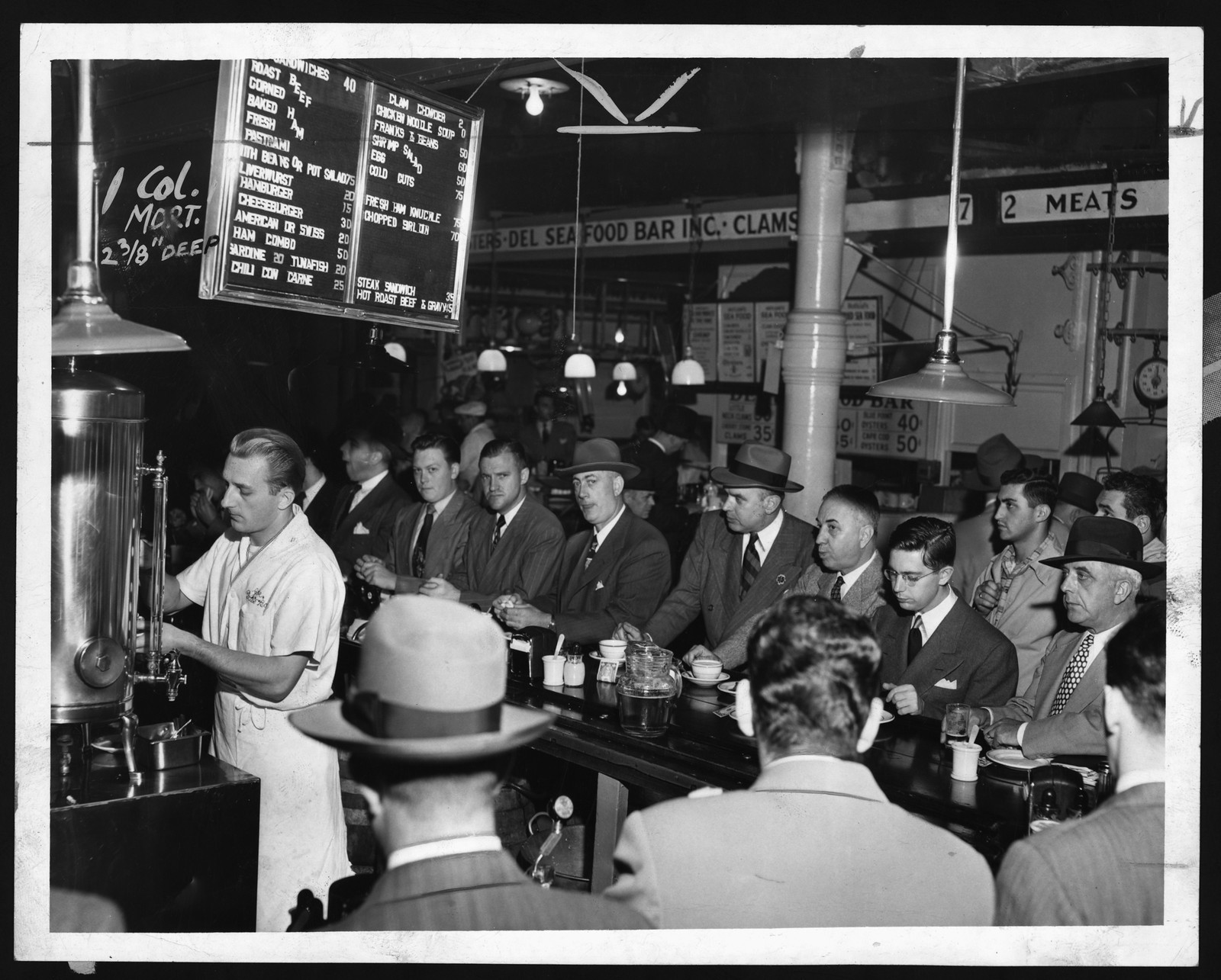 Men eating at a seafood bar lunch counter — historic image