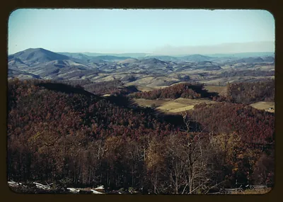 Autumn forested mountain ridges and valley farmland
