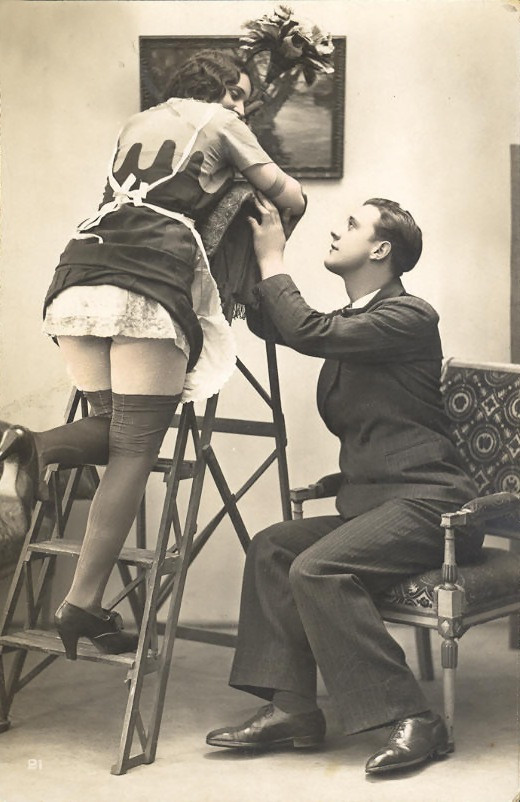 Sepia photograph of a maid on a stepladder and seated man — historic photograph