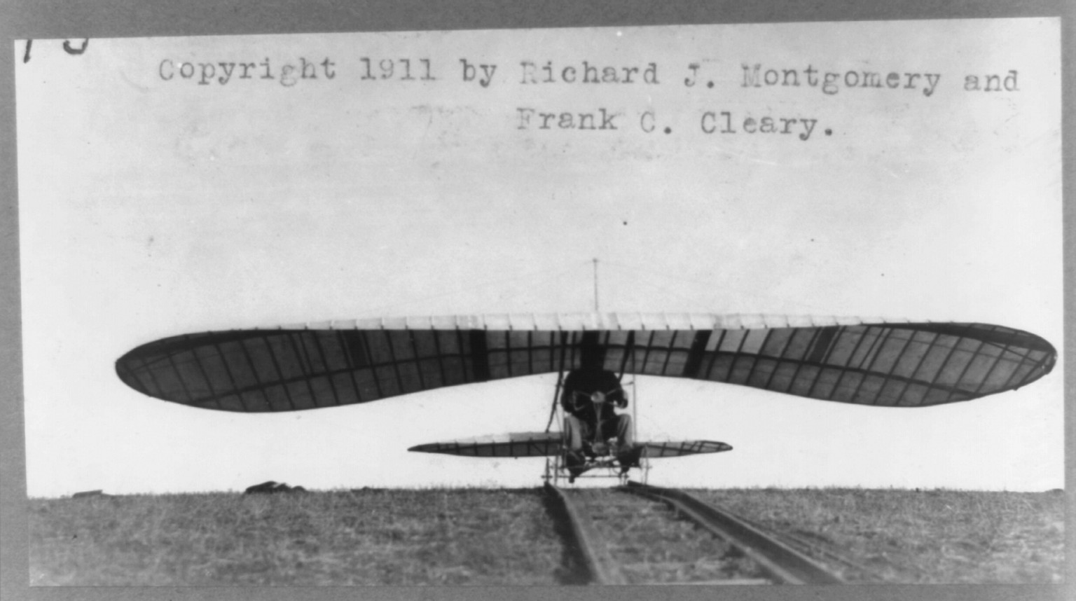 Con. Reinhardt in machine [glider] on track, c1911. — historic photograph