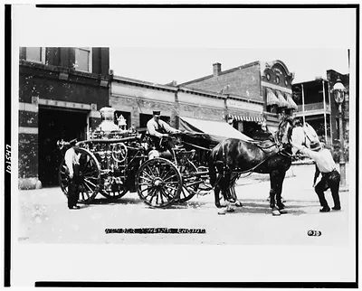 Horse-drawn fire engine of Engine Company No. 12 outside firehouse, 1626 North Capitol Street, N.W., Washington, D.C.