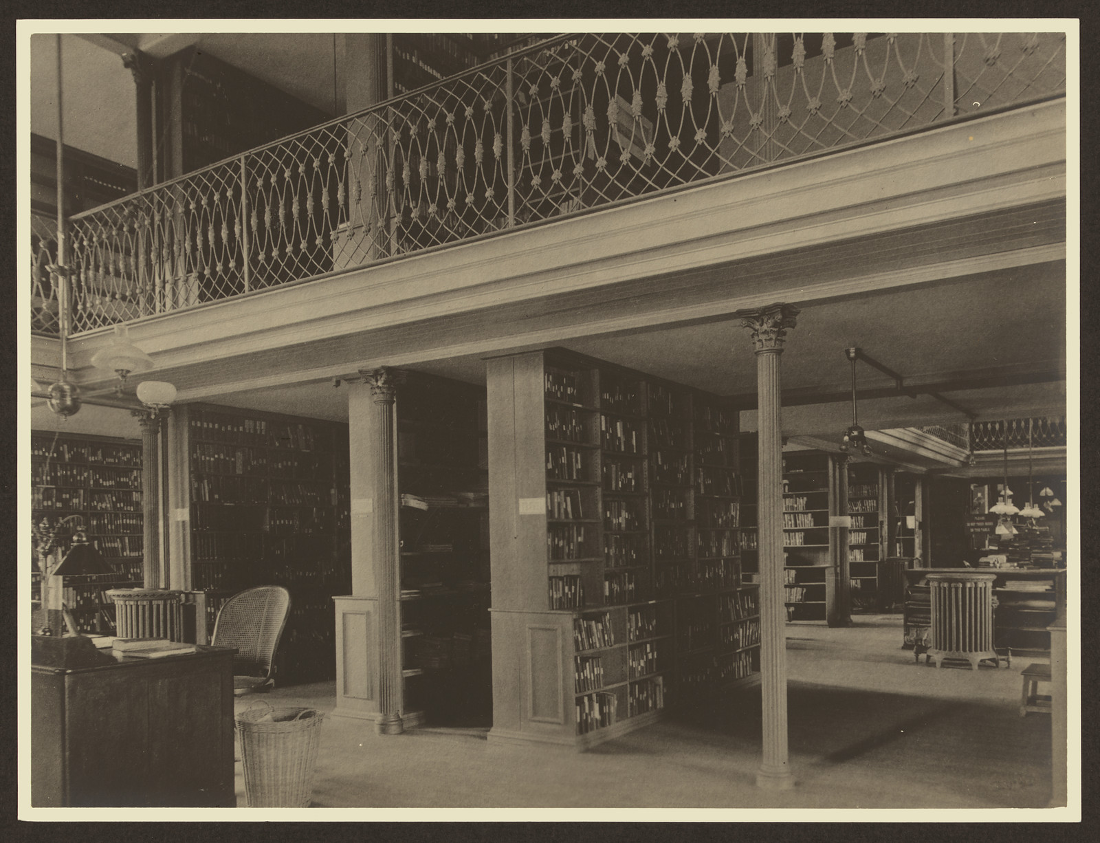 Library interior with gallery, alcoves and bookshelves — historic image