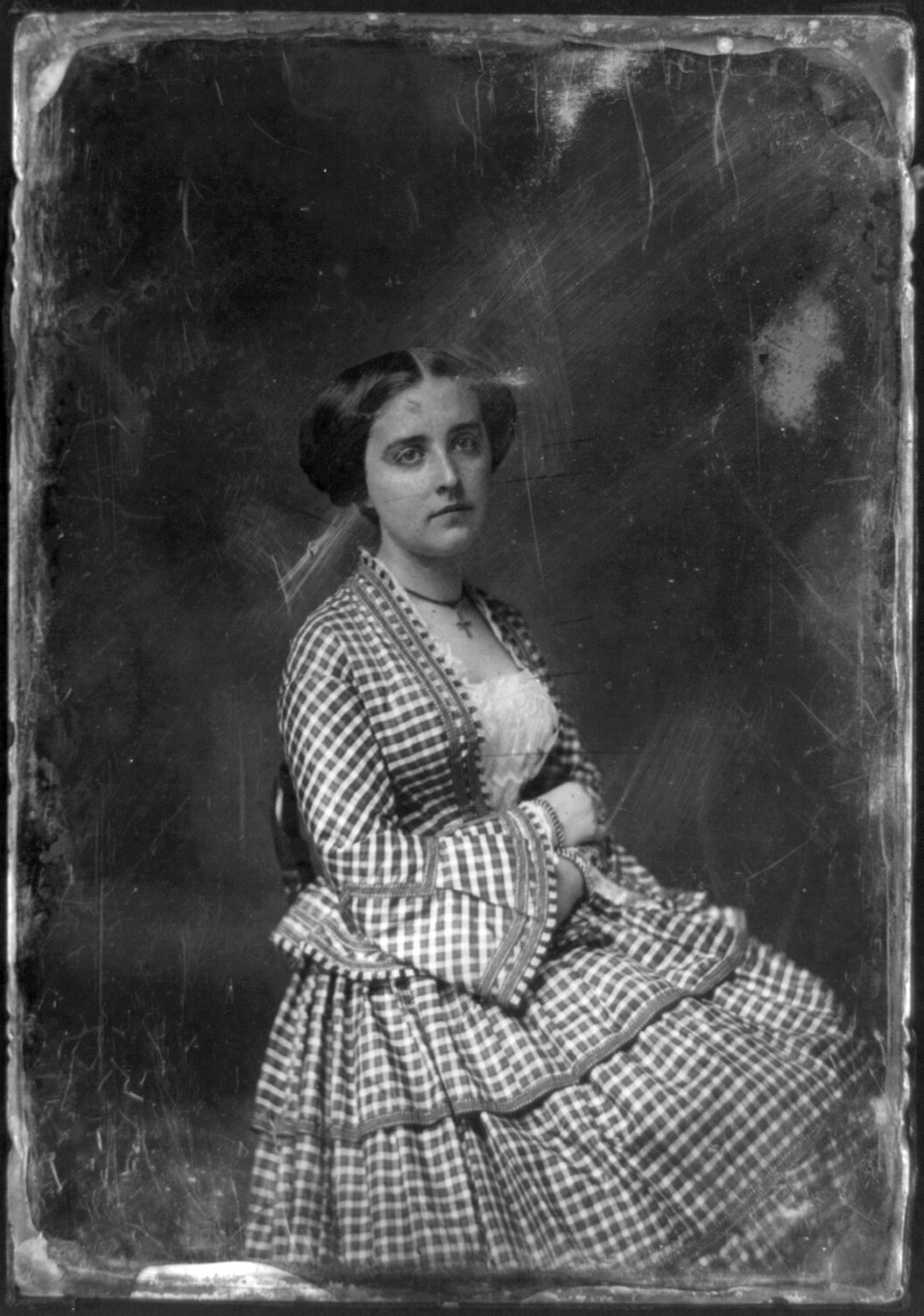 Seated woman in checked gingham dress, early photographic portrait, 1844 — historic photograph
