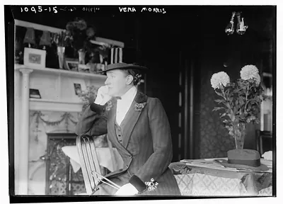Vera Morris seated in room in riding outfit