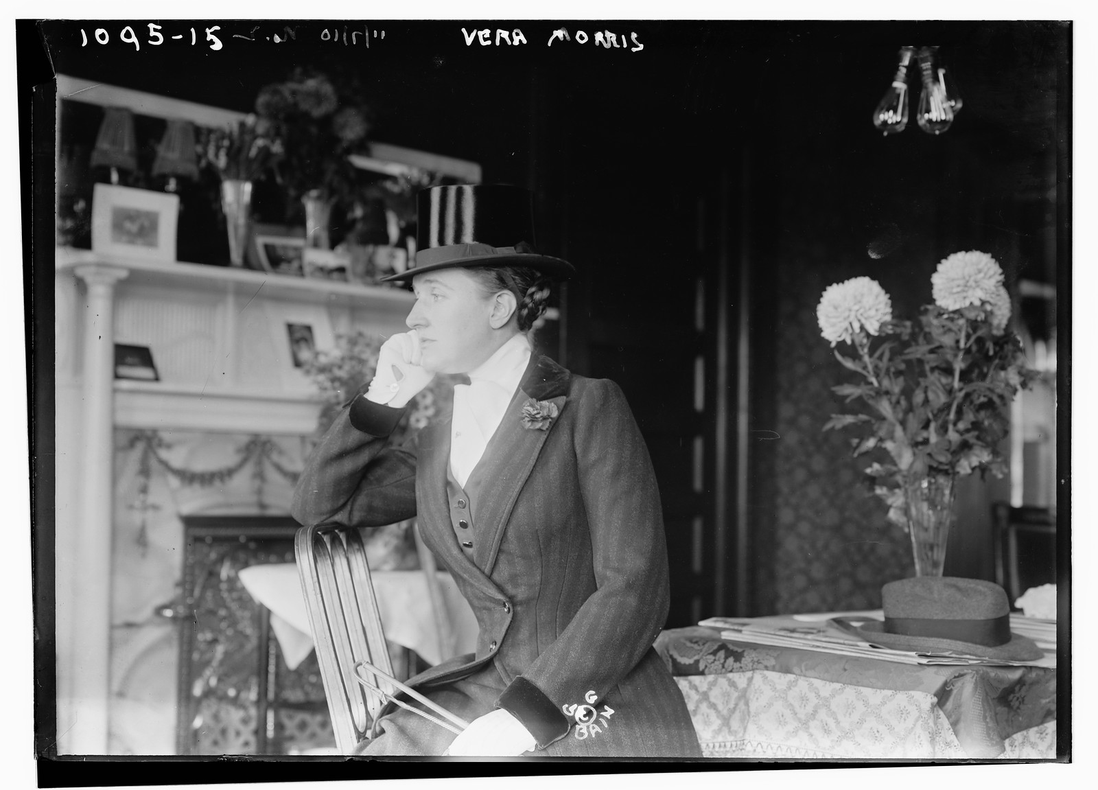 Vera Morris seated in room in riding outfit, 11/7/10. — historic photograph