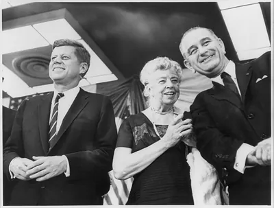 Mrs. Eleanor Roosevelt speaking ot Democratic vice presidential candidate Lyndon B. Johnson (right) as presidential candidate Sen. John F. Kennedy beams at crowd during rally at the New York Coliseum
