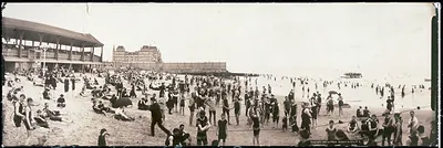 Crowded beach with bathers and pavilion, panoramic photograph, 1902