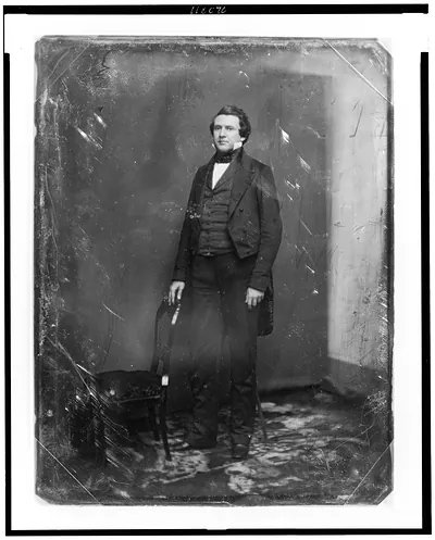 [Alexander Hugh Holmes Stuart, full-length portrait, standing slightly to the left, one hand resting on the back of a chair; studio background showing prominently]