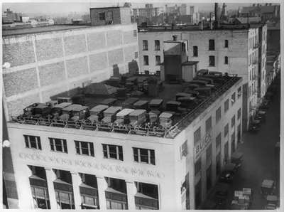 [Automobiles parked on roof of Buick Sales and service building]