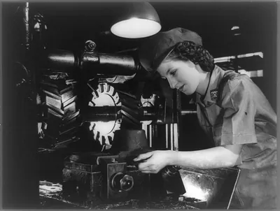 Paterson, N. J. (?). 1942 (?). Emily Rabbat making parts for airplane engines on a horizontal milling machine at a Wright Aeronautical Corporation plant. She formerly worked in a silk mill...for Wright Aeronautical Corp.