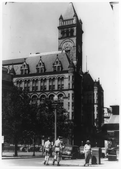 [Old Post Office, Washington, D.C.--Two soldiers walking in foreground at the corner of 10th and D Streets, N.W.]