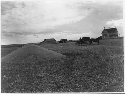 Farmer with horse and wagon in front of new and old homestead, 1917, Canada