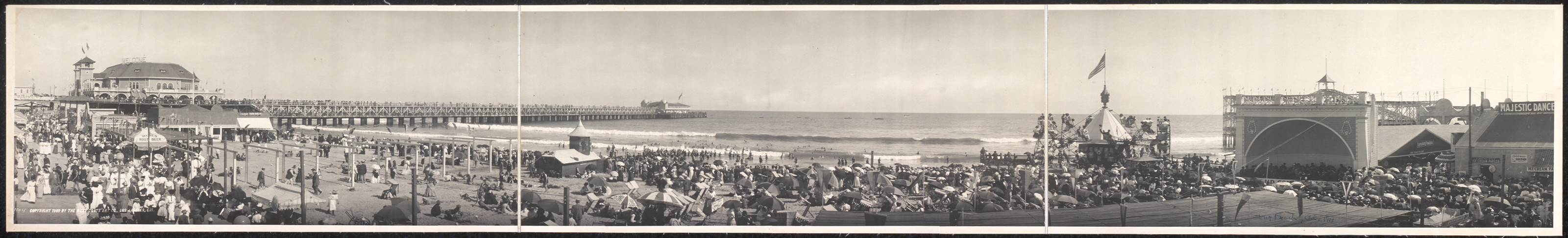 Panoramic view of crowded beach with pier and pavilion — historic image