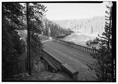 Canyon Bridge with roadway and concrete railings over river