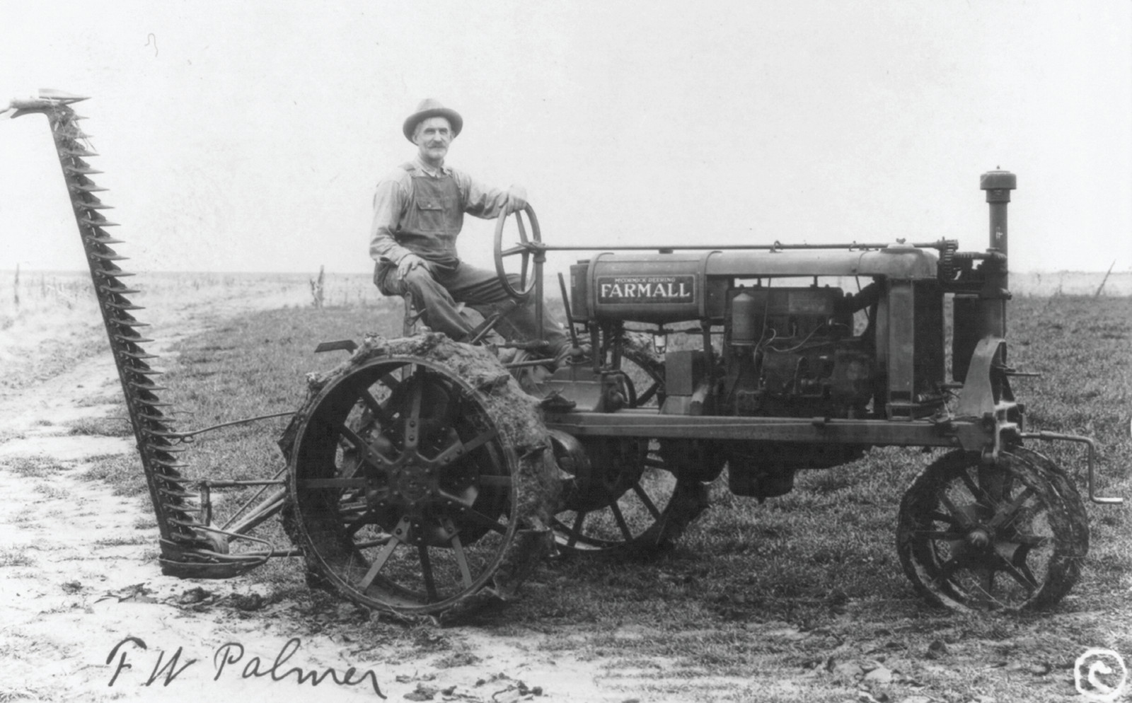 [Man operating a McCormick Deering Famrall tractor and reaper] — historic photograph
