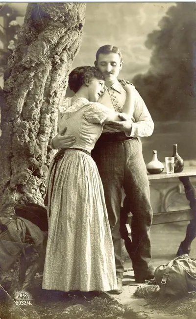 Couple embracing beside a tree, sepia studio postcard