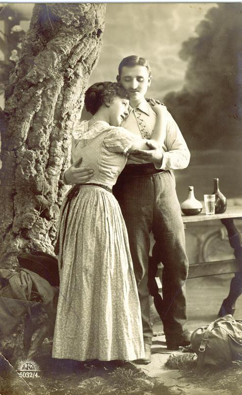 Couple embracing beside a tree, sepia studio postcard — vintage postcard