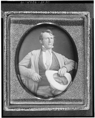 Seated man holding a white hat, daguerreotype portrait
